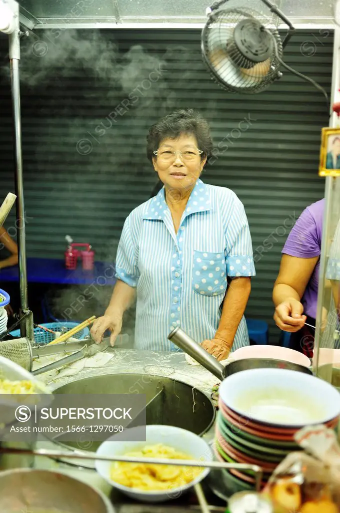 street vendor cooking in Thonburi district of Bangkok, Thailand.