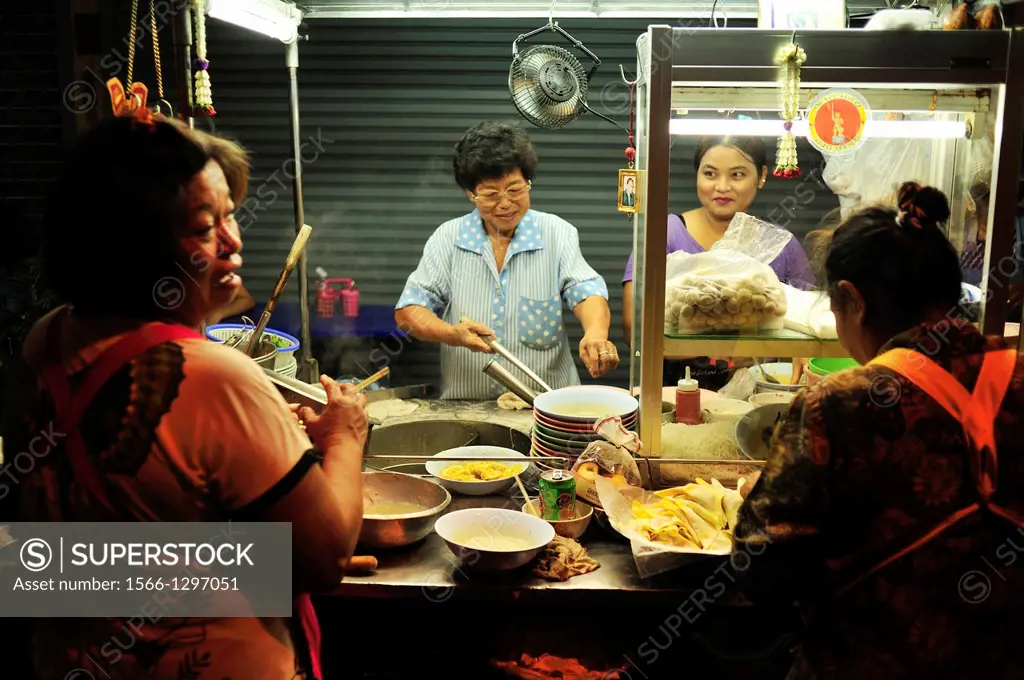 street vendors cooking in Thonburi district of Bangkok, Thailand.