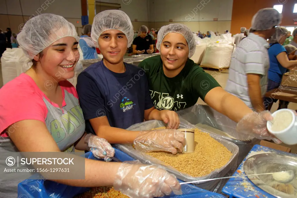 Florida, Miami, Miami-Dade County Fair And Expo, Feed My Starving Children, volunteer, community service, packing, meals, hairnet, Hispanic, teen, gir...