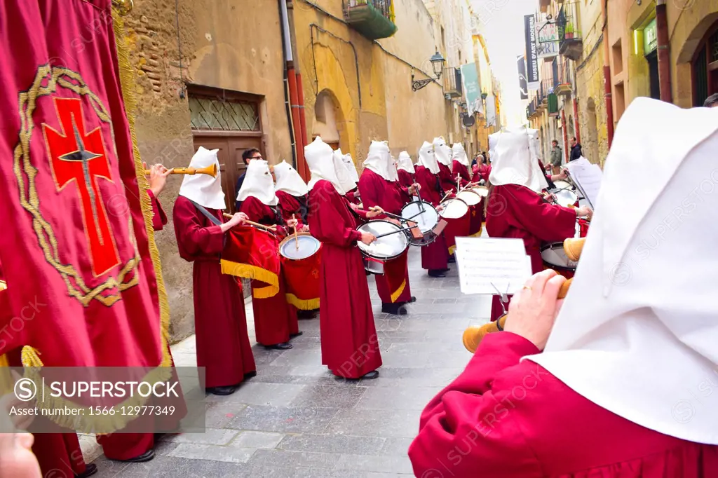 Masked drummers playing at Holy Week. Good Friday procession. Tarragona, Catalonia, Spain.