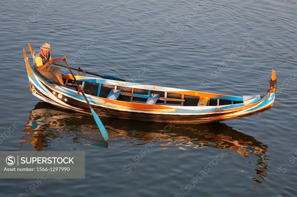Boatman rowing his boat on Taungthaman Lake, Amarapura, Mandalay, Myanmar, (Burma).