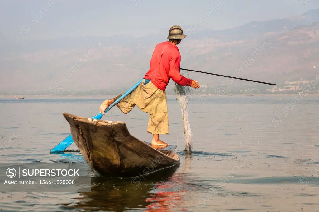 Intha fisherman fishing in a traditional fishing boat, Inle Lake, Nyaung Shwe, Shan State, Myanmar, (Burma).