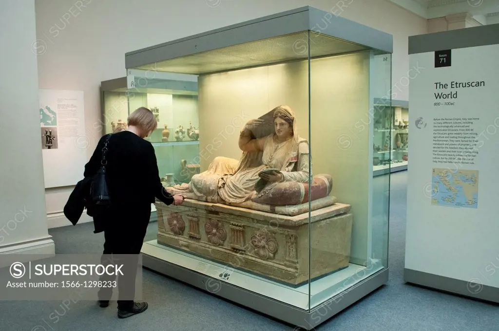 Woman taking photo of title of Painted terracotta sarcophagus of Seianti Hanunia Tlesnasa, Etruscan Art, British Museum, London, UK.