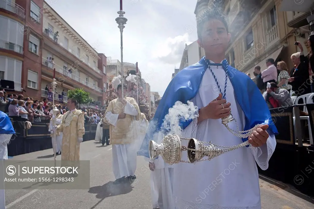 Young people in procession with incense burners in Holy week, Spain.