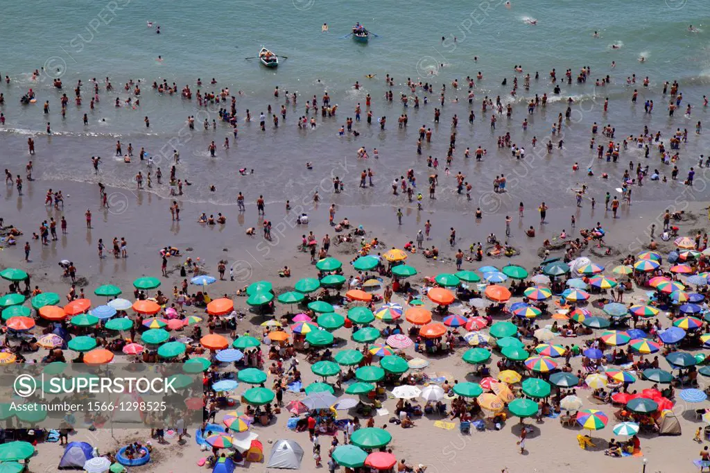 Peru, Lima, Barranco District, Malecon, Circuito de playas, Playa los Yuyos, Pacific Ocean, coast, aerial view, beach, crowd, crowded, umbrella, swimm...