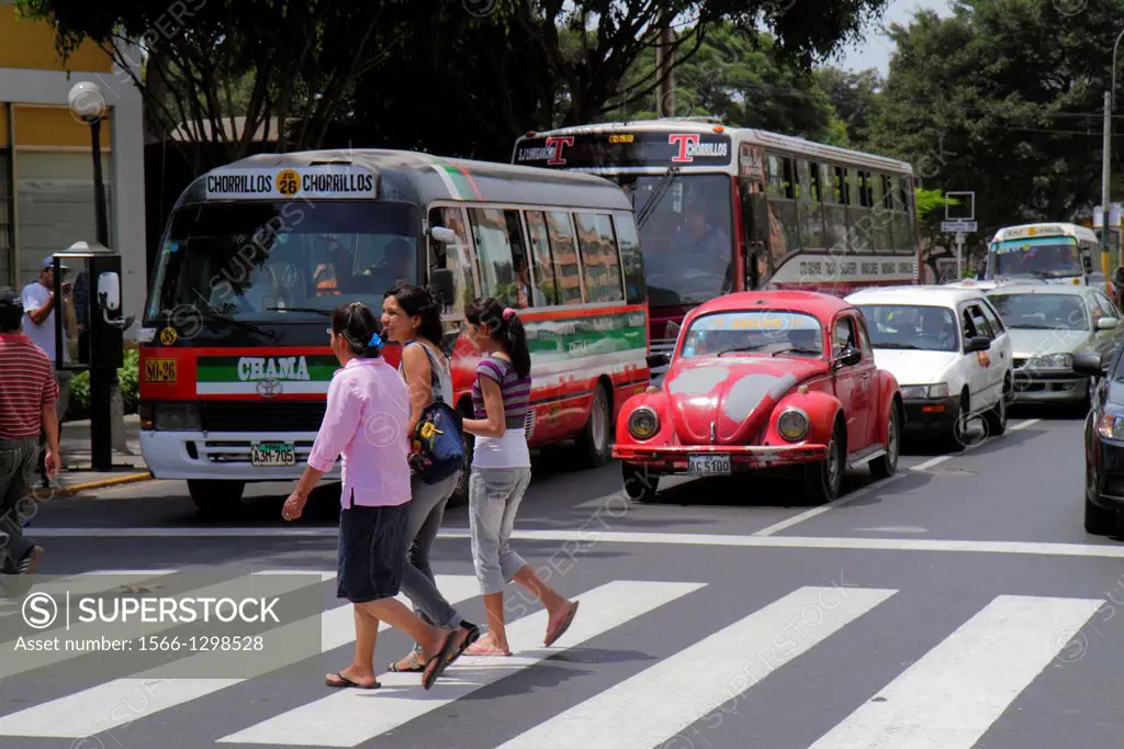 Peru, Lima, Barranco District, Avenida Miguel Grau, street scene, red light, stopped traffic, bus, car, Volkswagen, crossing, painted lines, Hispanic,...