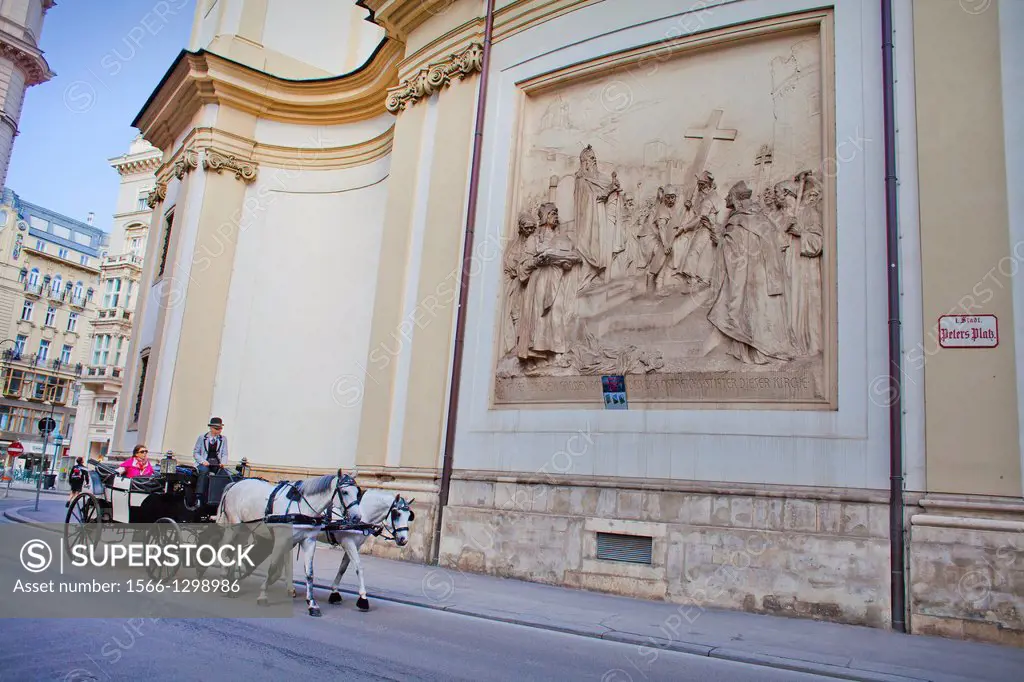 Horse carriage and side facade of Peterskirche (St. Peter Church),Vienna, Austria, Europe.