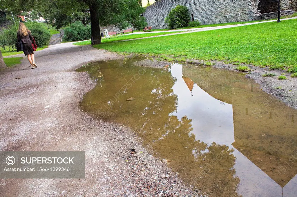 Reflected of old city wall on a puddle.