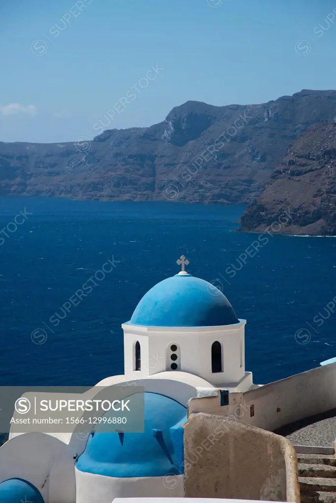 White church with blue chapel and caldera at Santorini in Greece