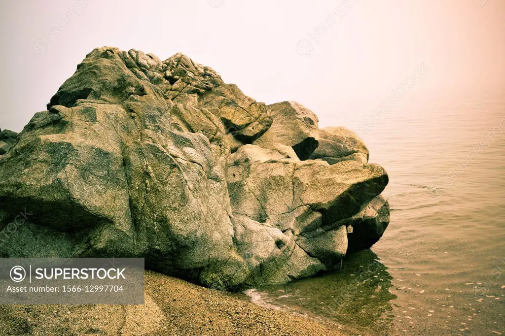 Rocks in a beach, near the sea.