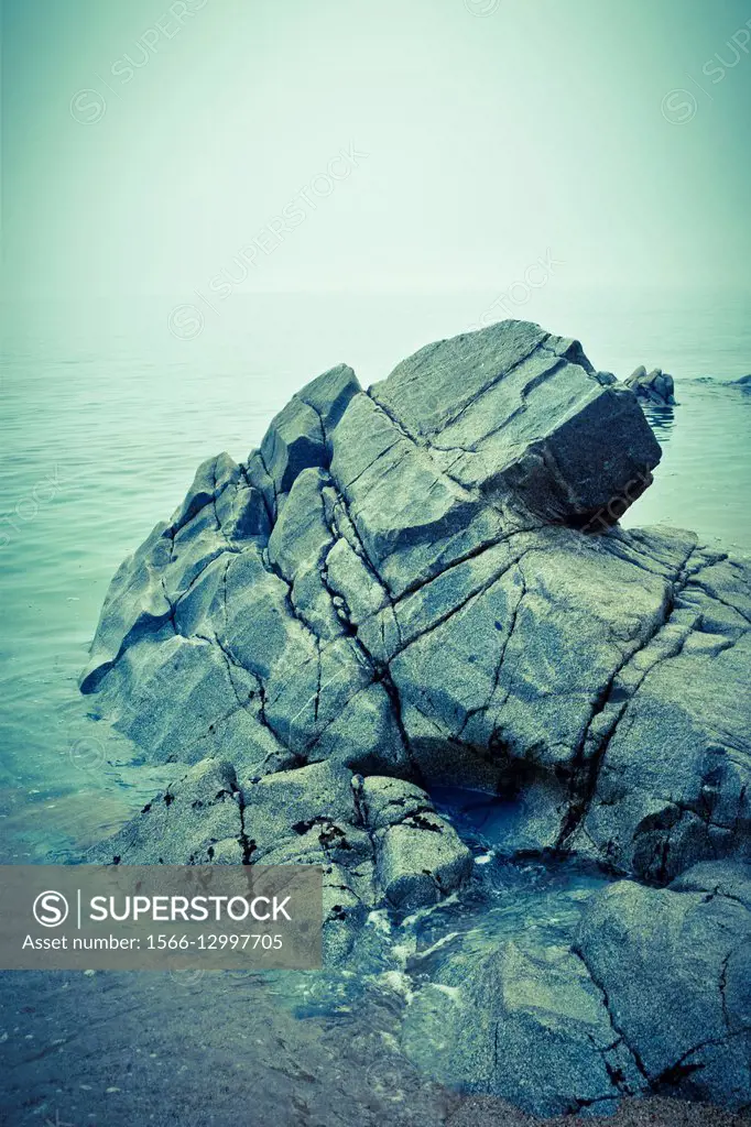 Rocks in a beach, near the sea.