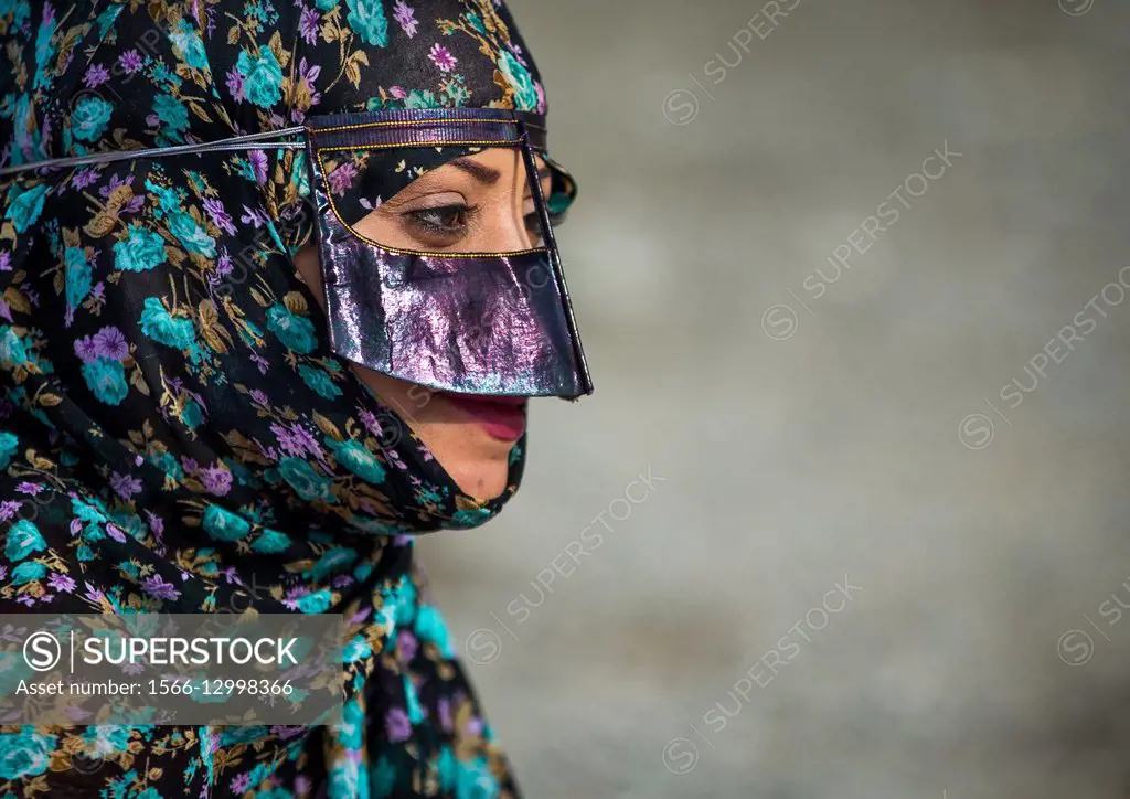 Iran, Hormozgan, Minab, a bandari woman wearing a traditional mask called the burqa at panjshambe bazar thursday market.