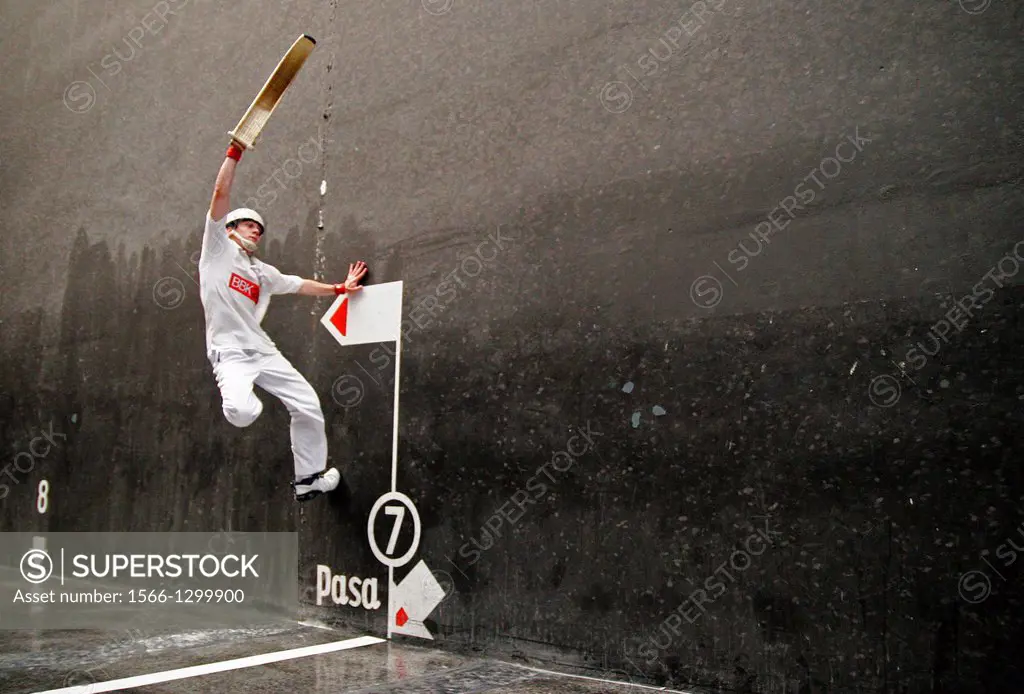jai alai player catches the ball in his wicker cesta, during a game in Guernica, Spain.