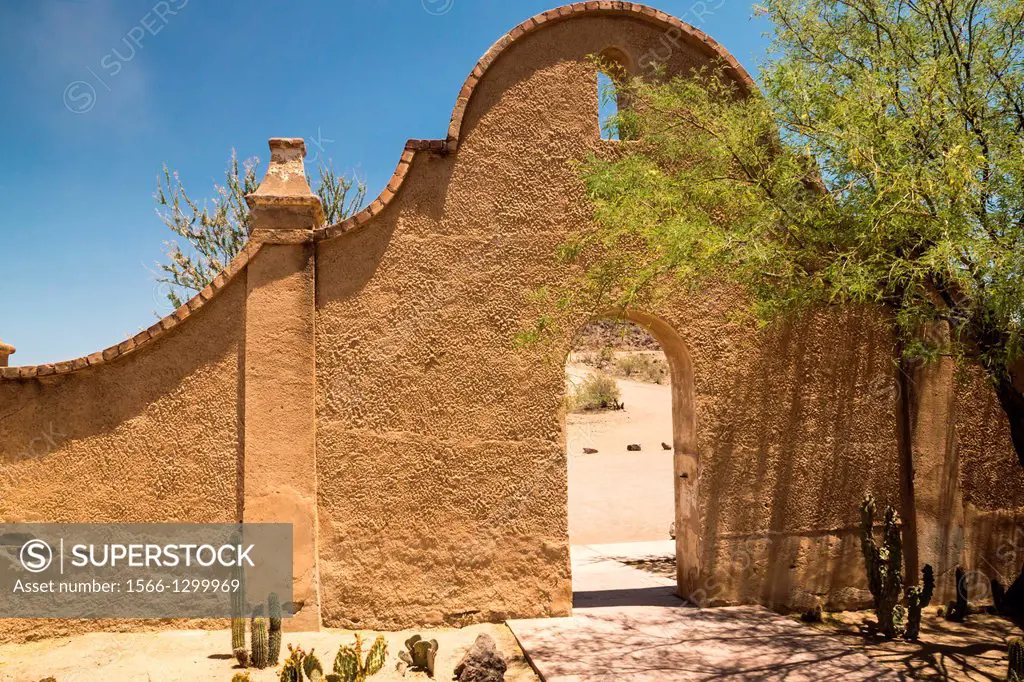 An arched wall and entry to Mission San Xavier shows the distinctice Spanish colonial influence of the architecture.