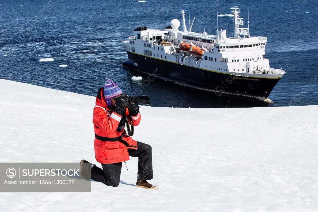 Staff from the Lindblad Expedition ship National Geographic Explorer (shown here is Nat Geo Photographer Kim Heacox) working in Antarctica.