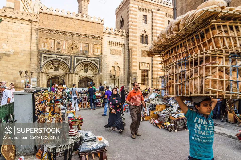 Child selling bread by Al-Azhar mosque. Cairo, Egypt.