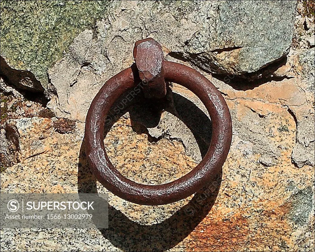 An old rusty iron ring used to tie up horses still remains embeded in this old stone wall located in Elko, Nevada.