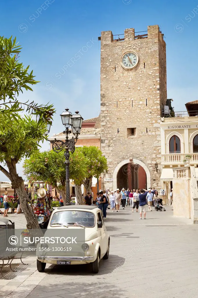 Fiat 500 car and Clock Tower in the background, Piazza IX Aprile, Taormina, Sicily, Italy.