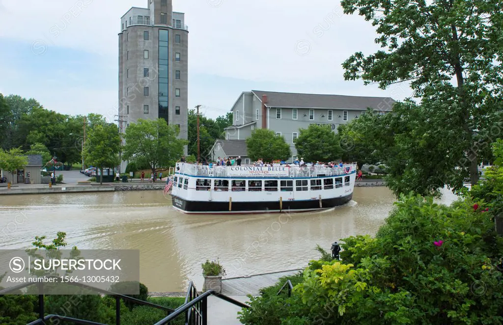 Rochester New York NY small town Pittsford village and famous historical Erie Canal with boat on canal water called Schoen Place.