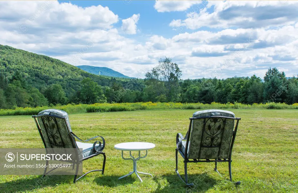 Weston Vermont relax on chairs scenic of mountains and Magic Mountain SKi Resort in distance summer clouds and sunshine wide open space.