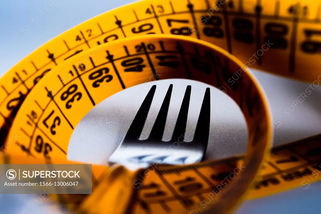 Fork and measuring tape. Concept of food and weight loss.