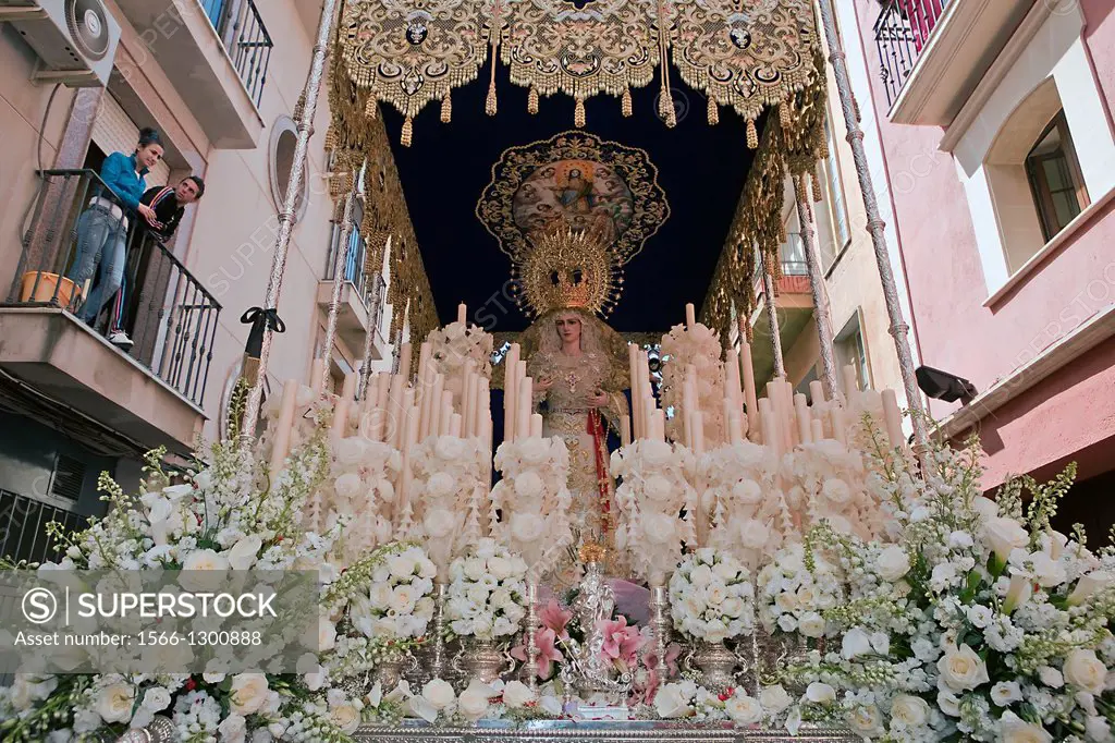 Front with candles, embroidered fabric and flowers of the throne of the Nuestra Señora del Amor Hermoso, Linares, Jaen province, Spain.