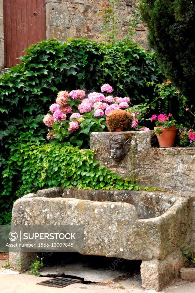 Aveyron, Midi-Pyrenees, , Castelnau-Pegayrolles, Parc des Grands Causses, old stone fountain.