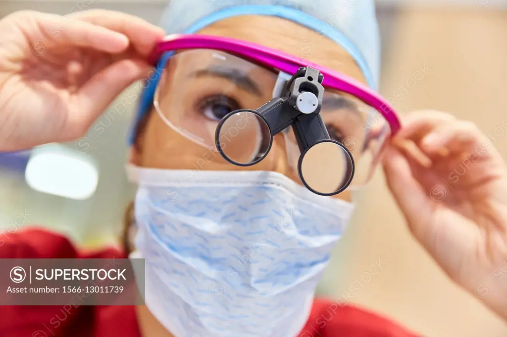 Surgeon with magnifying glasses. Surgical glasses. Plastic surgery.