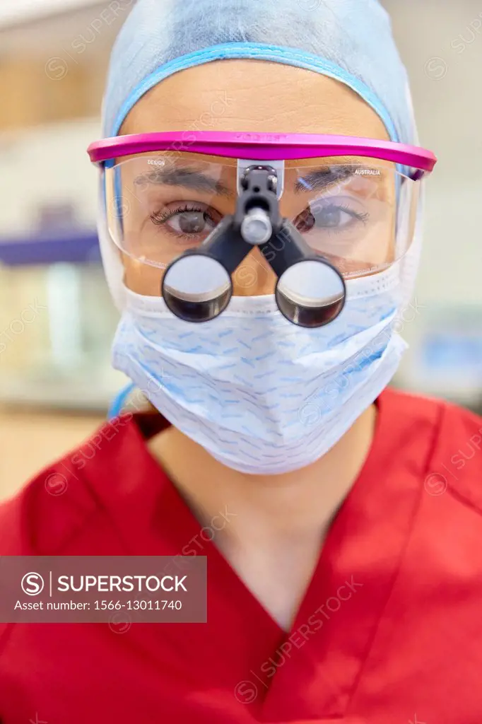 Surgeon with magnifying glasses. Surgical glasses. Plastic surgery.
