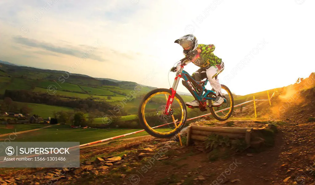 Downhill Mountain Biker Marc Beaumont leaving a trail of dust during a race at Moelfre, Wales.
