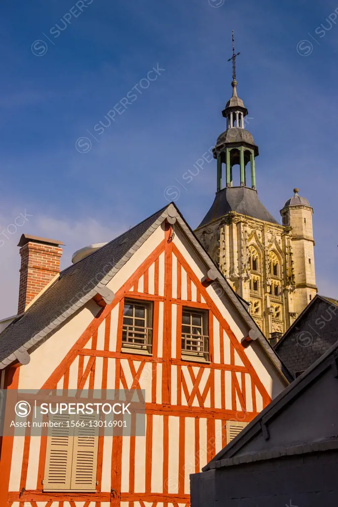 Medieval half timbered house, and Notre Dame de la Couture steeple basilica , in the backlground, Bernay, 27, Normandy, France.