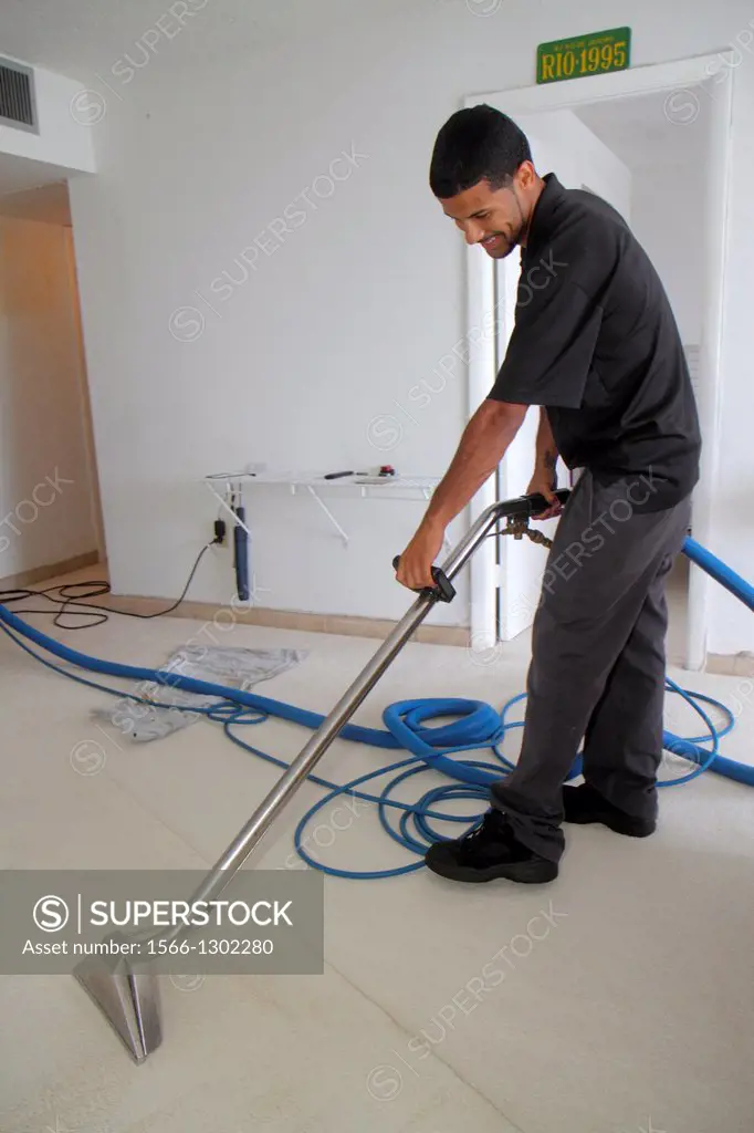 Florida Miami Beach Carpet Cleaning Cleaner Hispanic Man Coit Service Home House Vacuum Vacuuming Machine Uniform Job Working Superstock