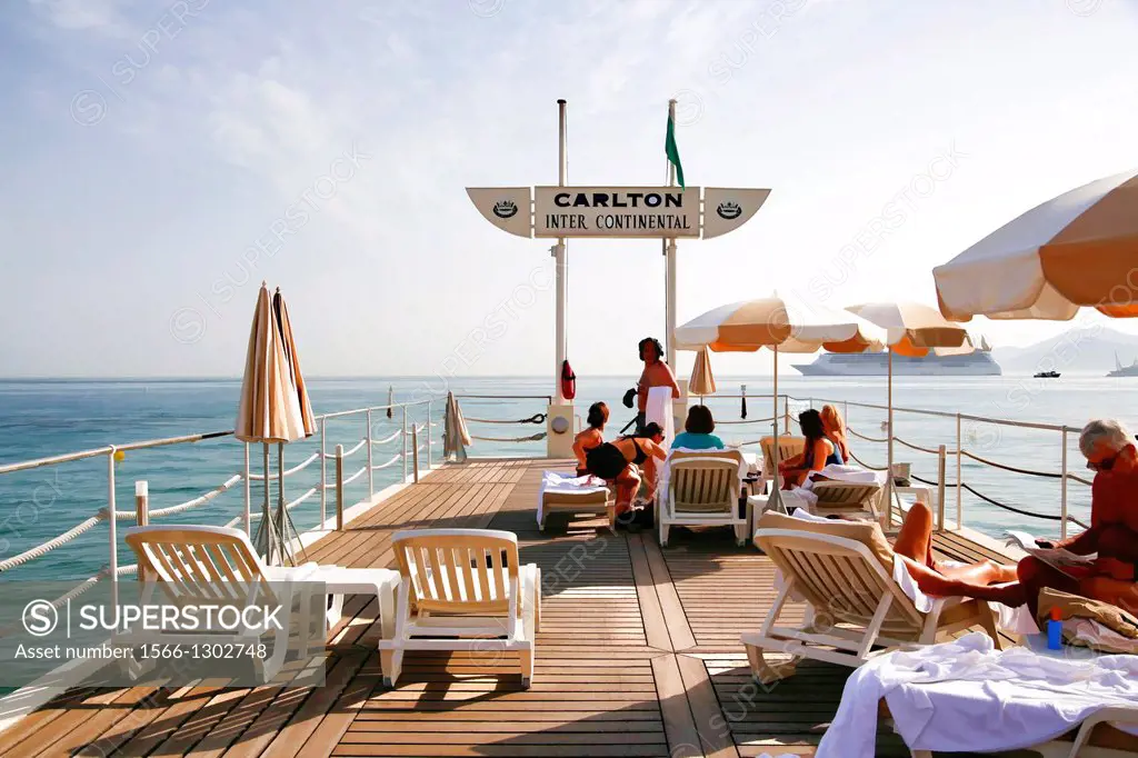 Guests on the Beach Pier of the Carlton Intercontinental Hotel, Cannes, French Riviera, France.