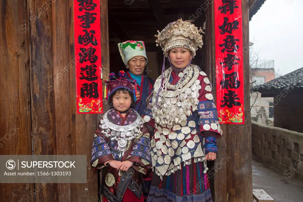 China , Guizhou province , Kalang village , Mushroom Miao people in traditional dress , woman and family.