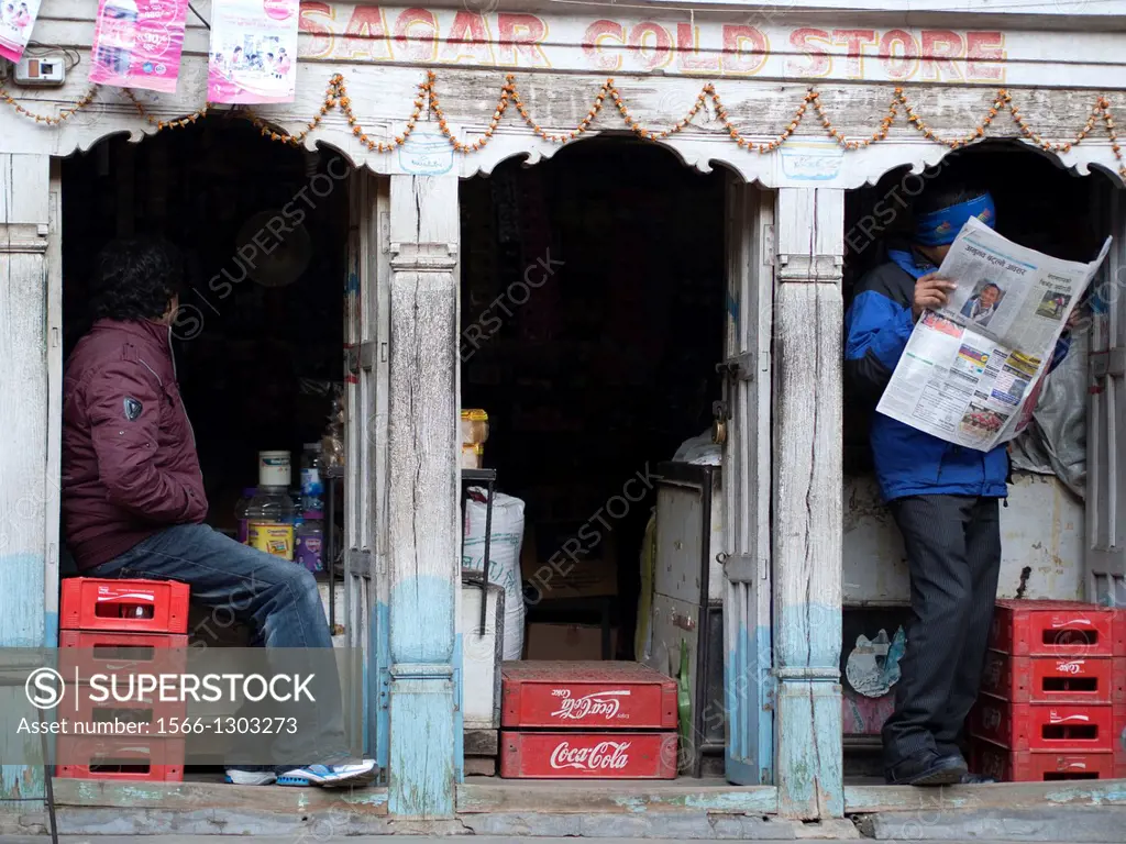 Two men hang out in a small shop in Patan, Nepal.