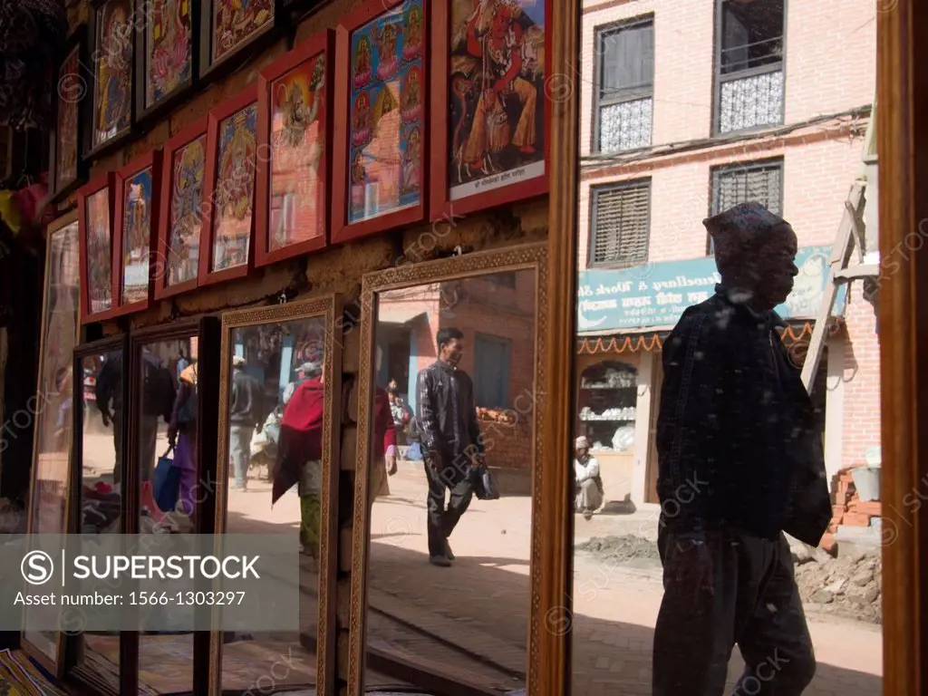 Mirrors reflect passerbys on a street in Bhaktapur, Nepal.