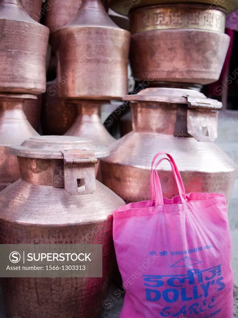 Metal canisters are stacked up at an outdoor market in Patan, Nepal.