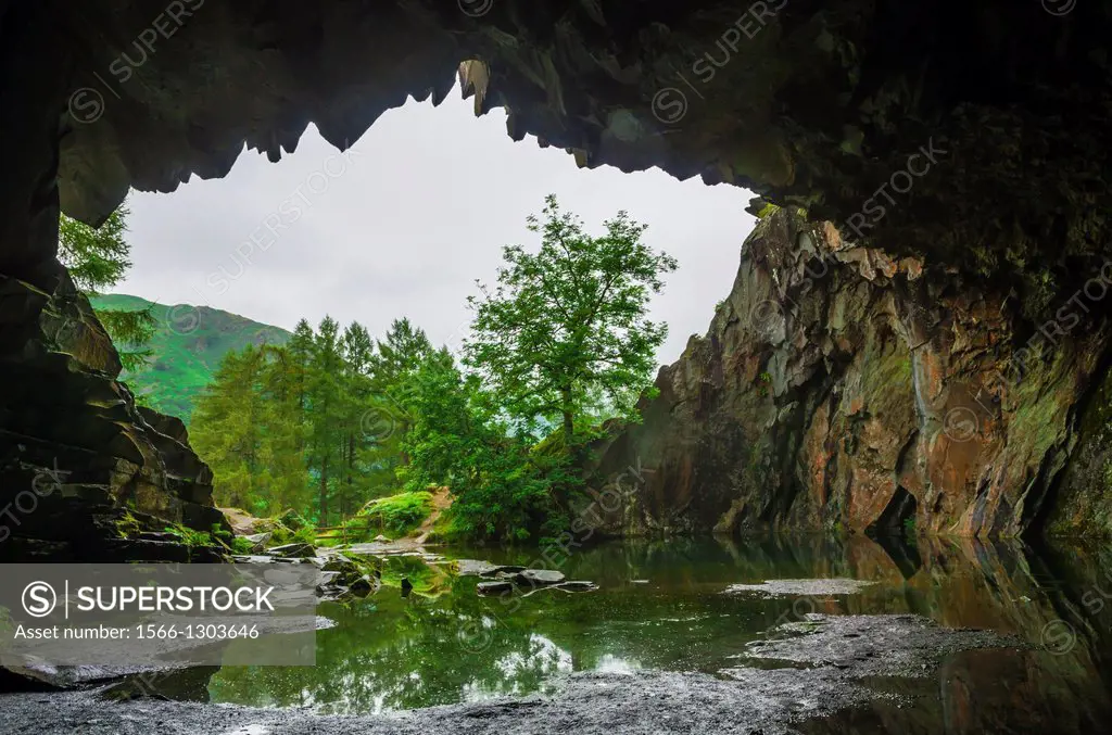 The mouth of an abandoned quarry cave on Loughrigg Fell in the Lake District, Cumbria, England.
