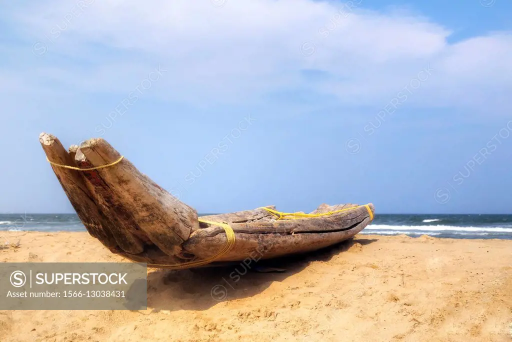 traditional wooden fishing boat on Kovalam beach, Covelong, Chennai, Tamil Nadu, India.