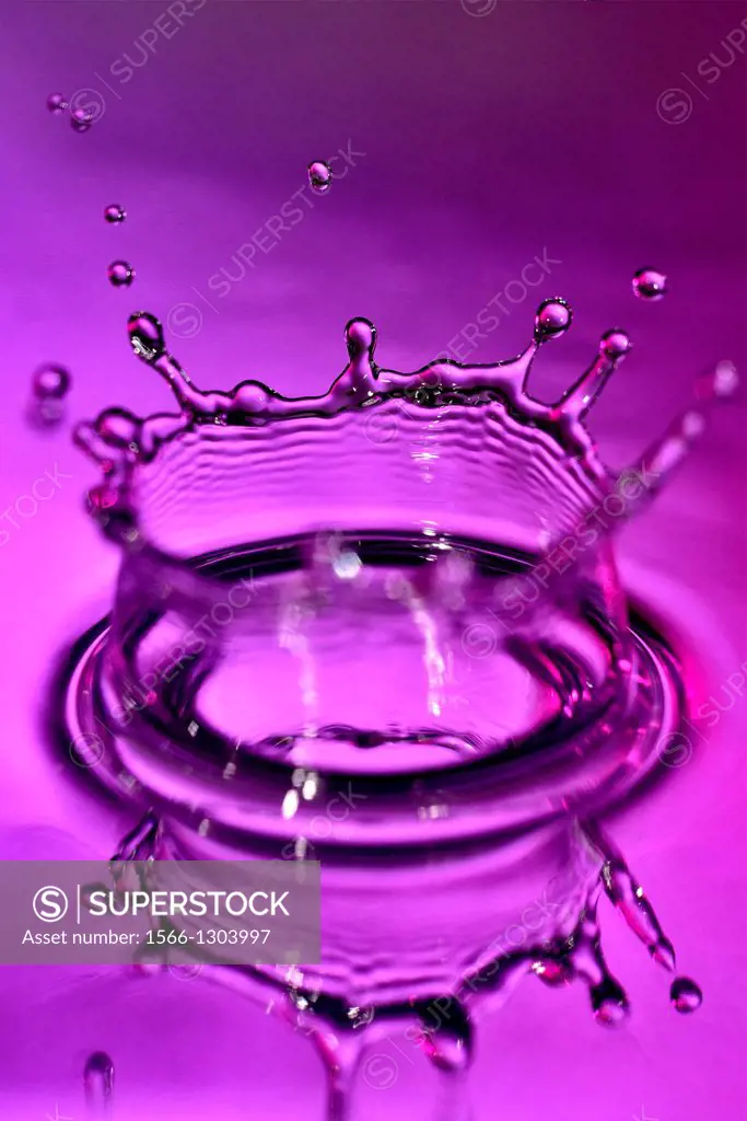 High-speed photograph of a water drop impacting on water showing secondary drops formation