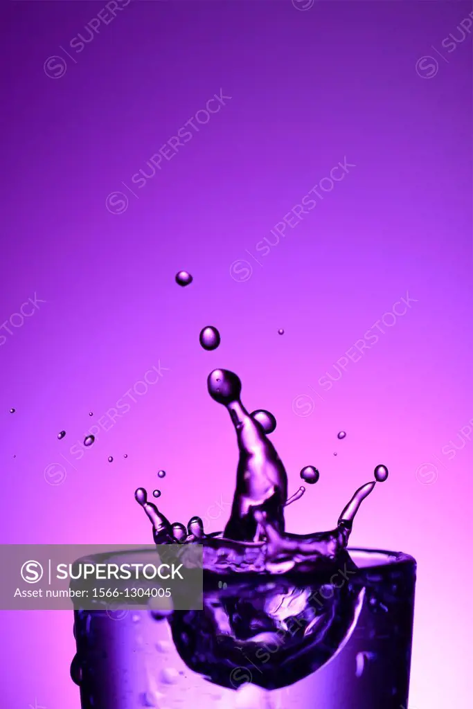 High-speed photograph of a water drop impacting on water showing secondary drops formation
