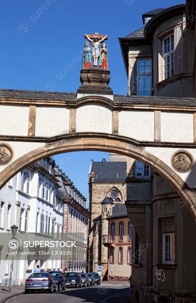 Archway with a crucifixion group near Liebfrauenbasilika church, Trier, Rhineland-Palatinate, Germany, Europe.