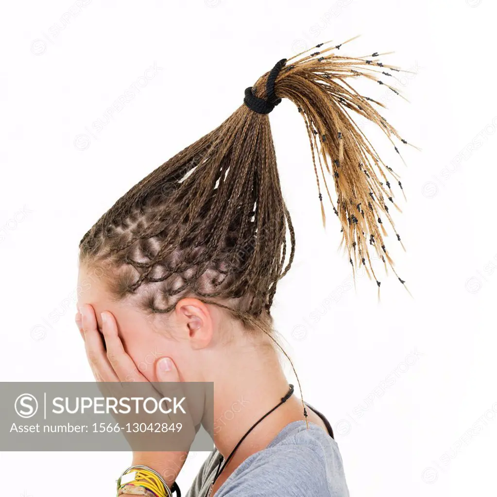 Blonde girl with braids magically raised, covers her face with her hands.