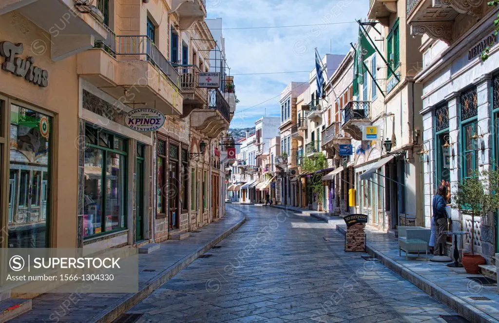 Street in downtown area of capital of Syros called Hermoupolis with shops.