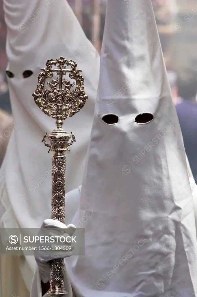 Penitent with staff of silver during a procession of holy week on Palm Sunday, Spain.