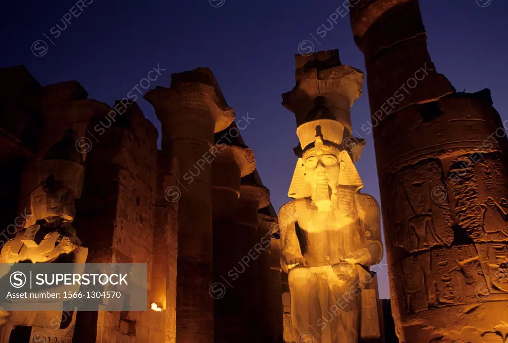 EGYPT, NILE RIVER, LUXOR, TEMPLE OF LUXOR, STATUE OF RAMSES II AT ENTRANCE TO GREAT COLONNADE.