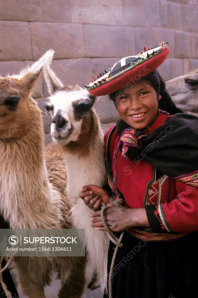 PERU, CUZCO, LOCAL WOMAN WITH LLAMAS.