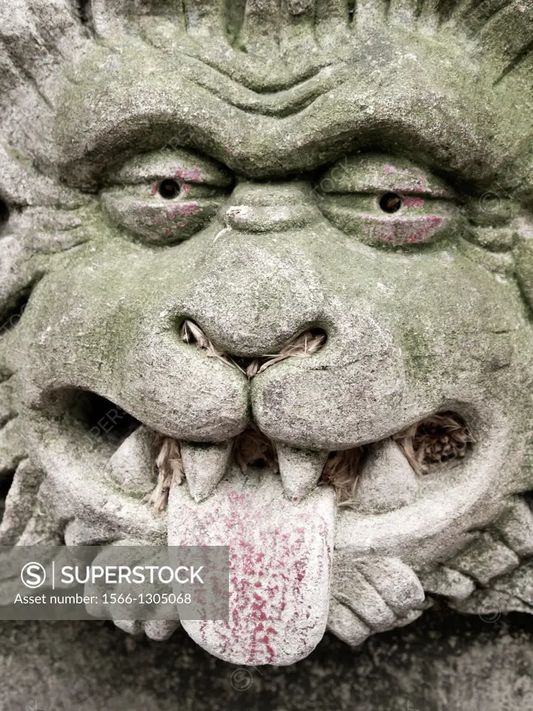 England, North Yorkshire, York City. Gargoyle on bench in Dean's Park in the grounds of York Minster cathedral.
