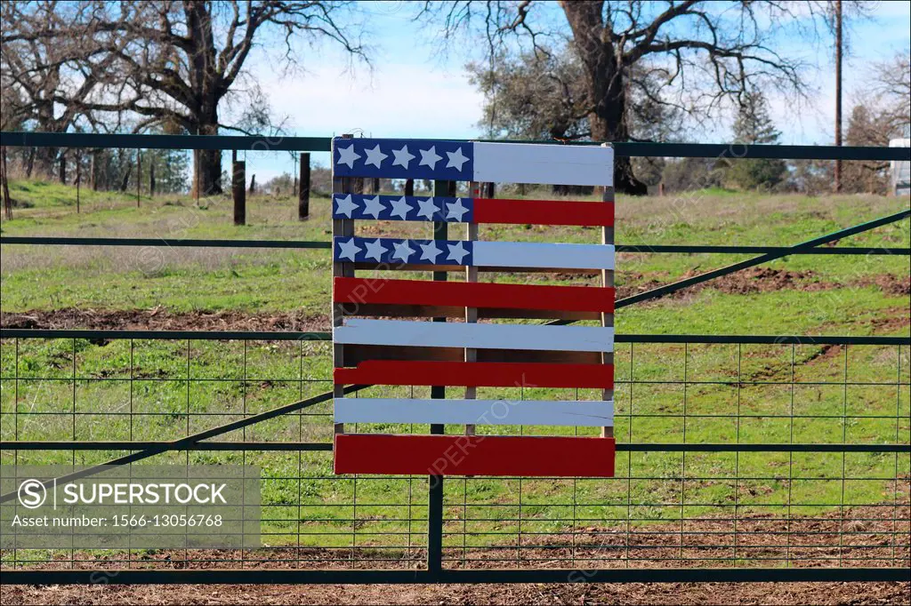 A wooden American flag decorates a fence in Somerset, California, USA