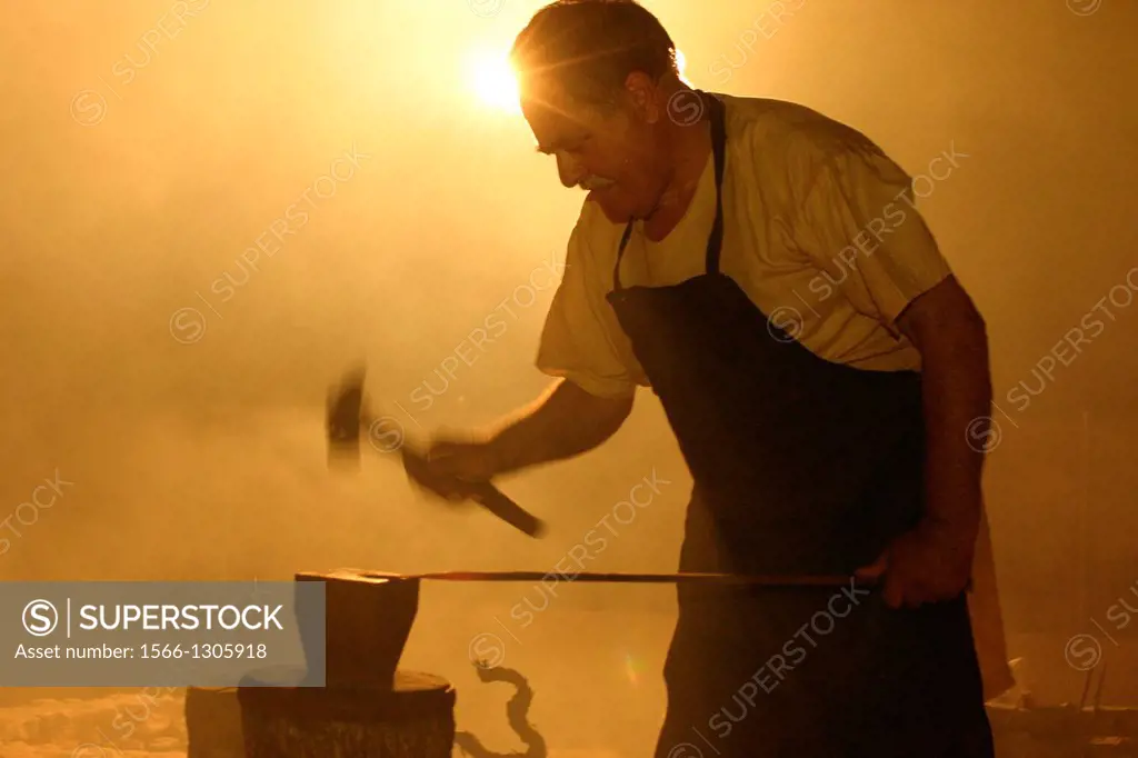 Smith working on metal with a hammer
